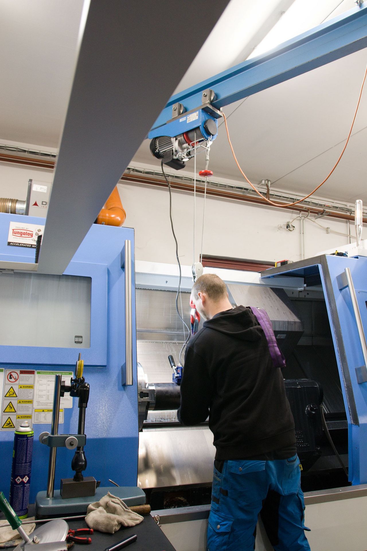 Operating a lathe in the production hall